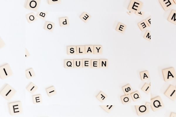 scrabble pieces with words slay queen